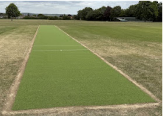 The finished brand new green artificial cricket pitch on school cricket field